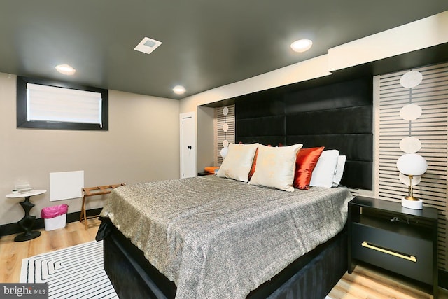 bedroom with light hardwood / wood-style floors