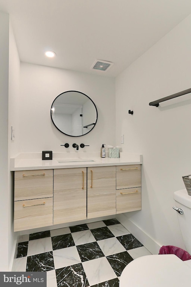 bathroom featuring vanity and toilet