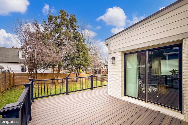 wooden terrace with a lawn