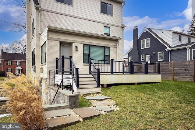 rear view of house featuring a yard