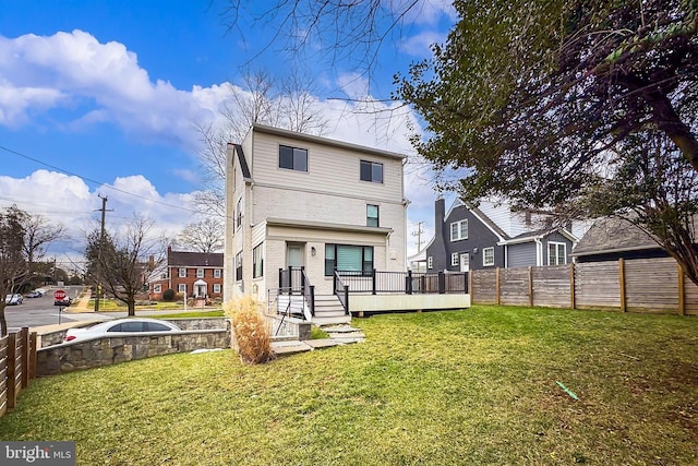 rear view of house featuring a yard