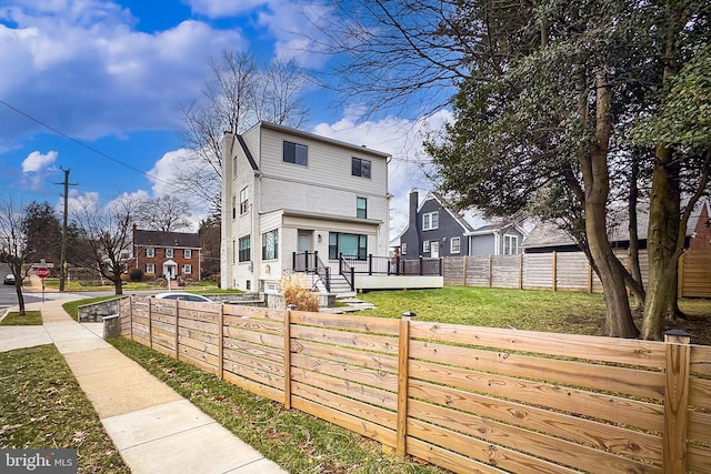 rear view of house featuring a yard