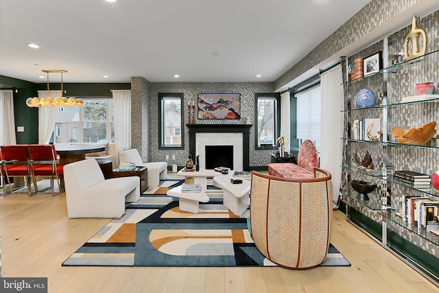 living room featuring a chandelier and light wood-type flooring