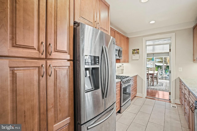 kitchen featuring appliances with stainless steel finishes and light tile patterned floors