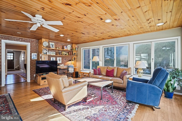 living room with hardwood / wood-style flooring, ceiling fan, brick wall, and wooden ceiling