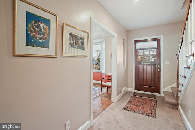 entryway featuring light carpet