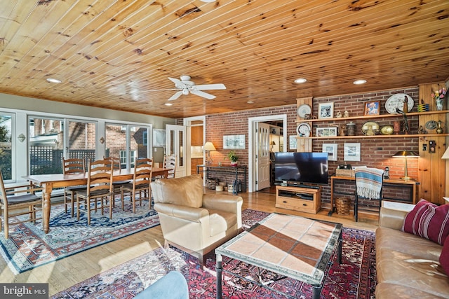 living room with ceiling fan, brick wall, wood ceiling, and hardwood / wood-style floors