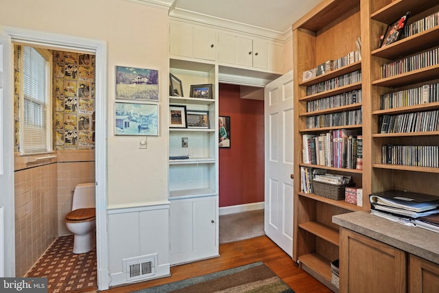 interior space with tile walls and dark hardwood / wood-style floors