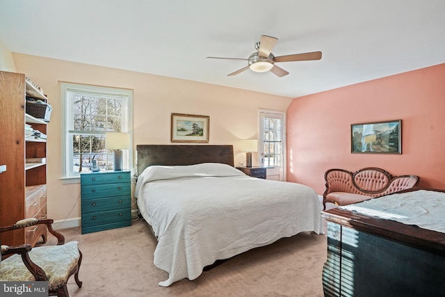 carpeted bedroom featuring ceiling fan, lofted ceiling, and multiple windows