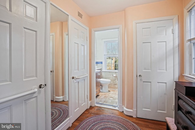 doorway to outside featuring dark wood-type flooring