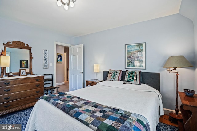 carpeted bedroom with vaulted ceiling