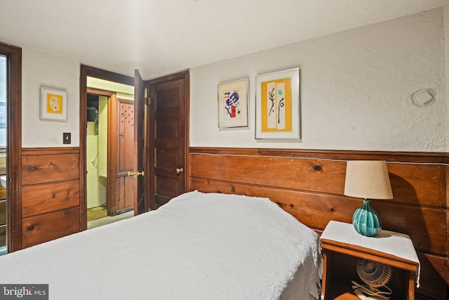 bedroom with wooden walls