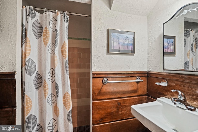 bathroom with sink and curtained shower