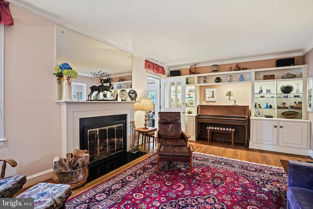 living room with ornamental molding and light hardwood / wood-style flooring