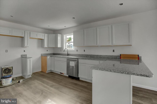 kitchen featuring sink, light hardwood / wood-style flooring, light stone countertops, white cabinets, and stainless steel dishwasher