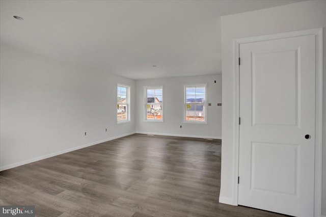 spare room featuring dark hardwood / wood-style flooring