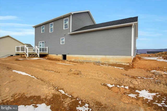 back of house featuring a wooden deck