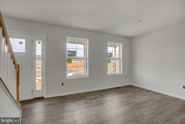 unfurnished room with dark wood-type flooring