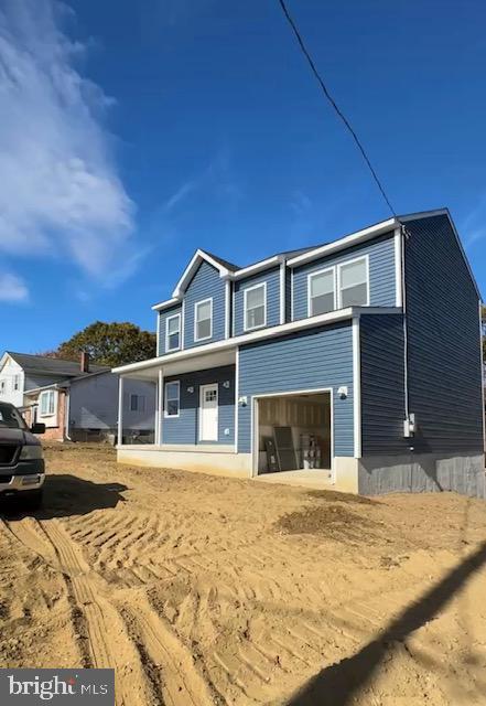 view of front of home with a garage and a porch