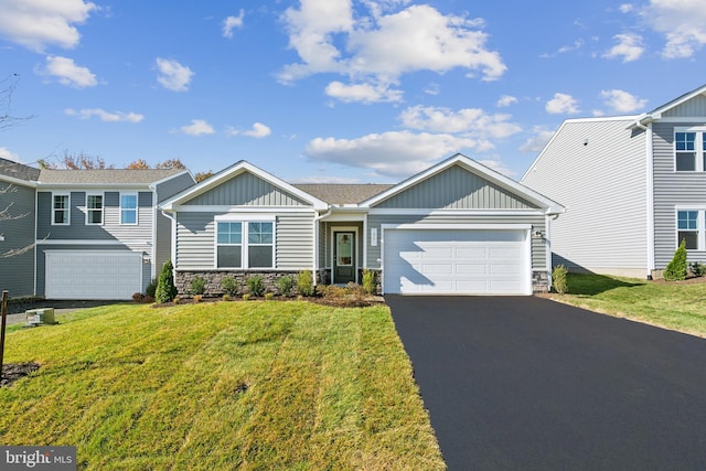 view of front of home with a front lawn and a garage