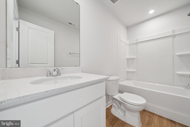 full bathroom featuring toilet, shower / tub combination, hardwood / wood-style floors, and vanity