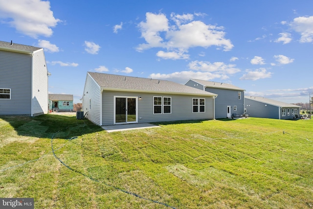 back of house with a patio area, central AC, and a lawn