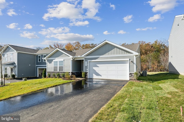 view of front of home with a front lawn, a garage, and cooling unit