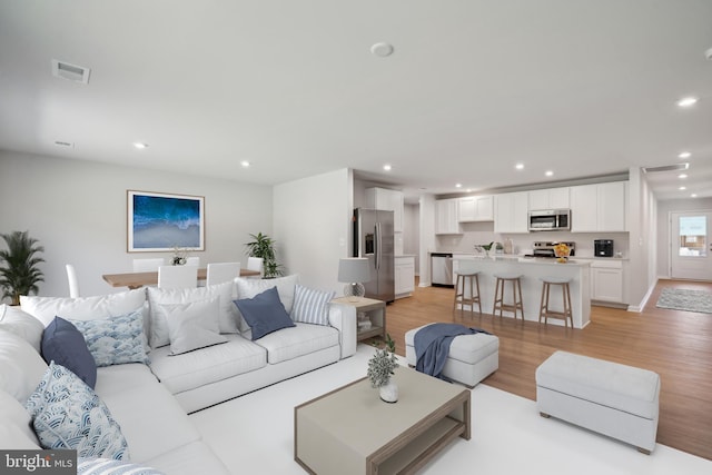 living room with light hardwood / wood-style floors