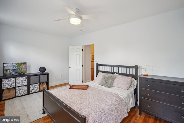 bedroom with ceiling fan and dark wood-type flooring