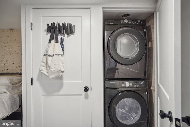 laundry area featuring stacked washer / dryer