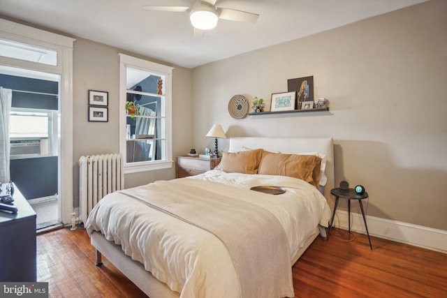 bedroom with ceiling fan, cooling unit, wood-type flooring, and radiator heating unit