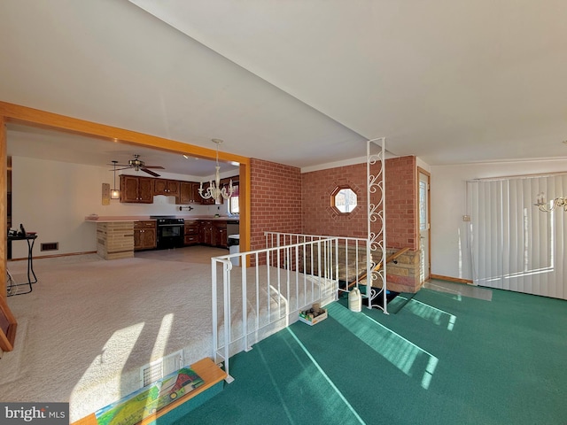 2140 Hyndman Rd, Hyndman, PA 15545 - stairway featuring ceiling fan, brick wall, and carpet flooring
