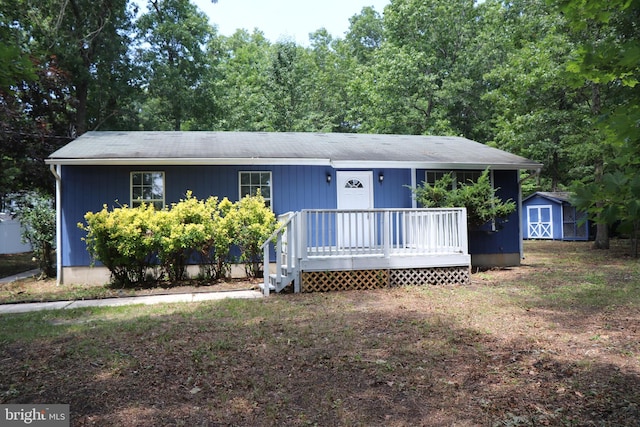 view of front of home with a storage unit and a wooden deck