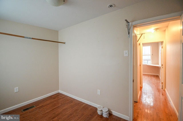 unfurnished room with hardwood / wood-style floors