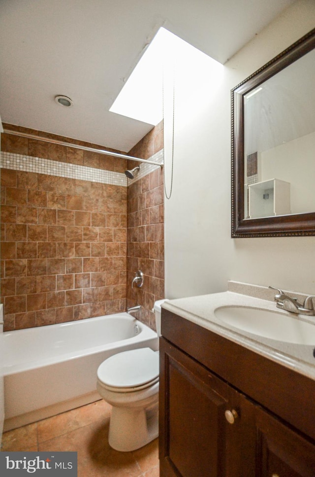 full bathroom with toilet, tile patterned flooring, tiled shower / bath, and vanity