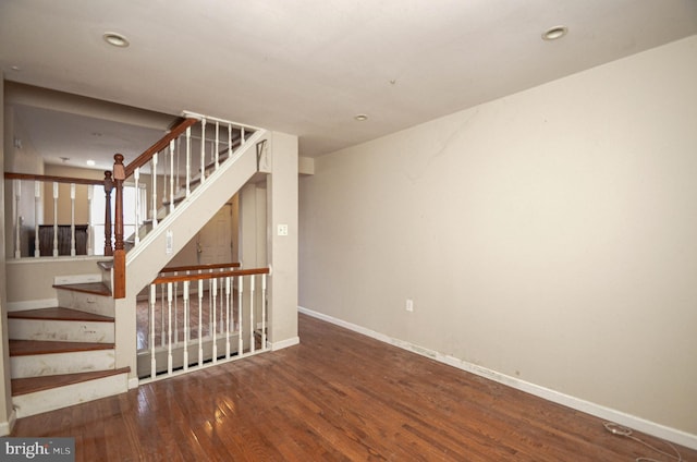 stairs featuring hardwood / wood-style floors