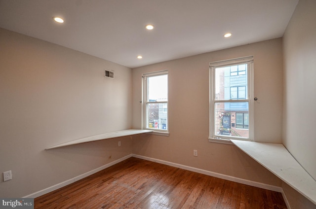 spare room with hardwood / wood-style floors