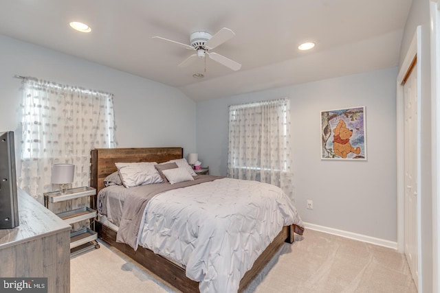 carpeted bedroom featuring ceiling fan, a closet, and lofted ceiling