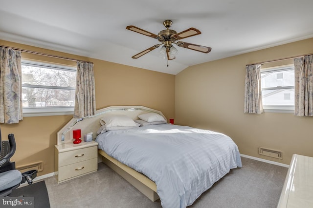 bedroom featuring lofted ceiling, multiple windows, light carpet, and ceiling fan