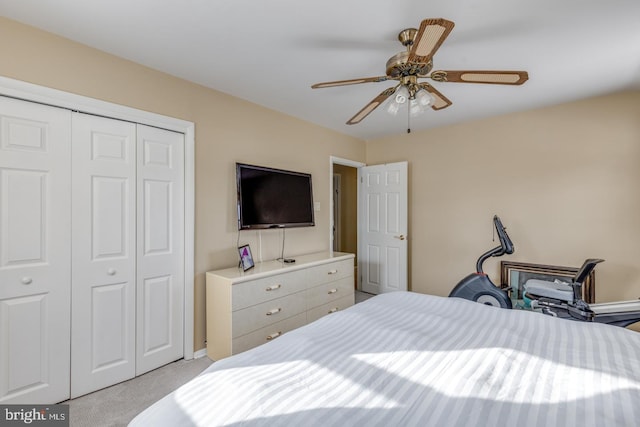 carpeted bedroom featuring a closet and ceiling fan