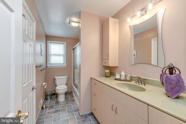 bathroom with vanity, toilet, and a shower with shower door