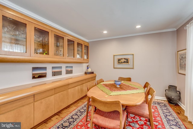 dining area with light parquet floors and ornamental molding