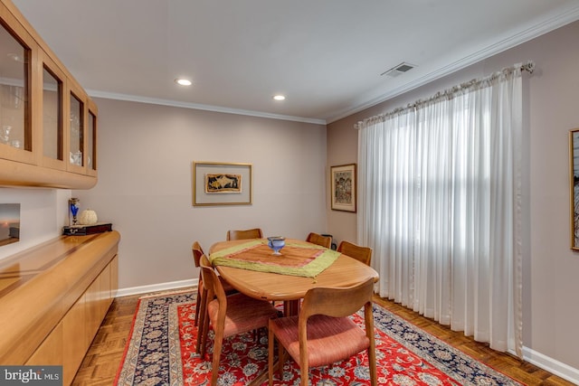 dining room with dark parquet flooring and crown molding