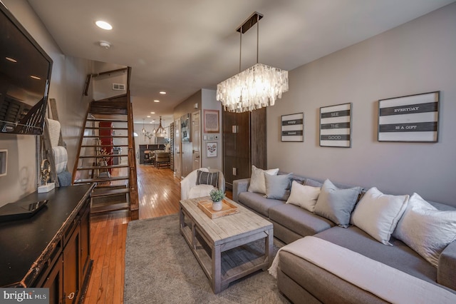 living room with dark hardwood / wood-style floors and a notable chandelier