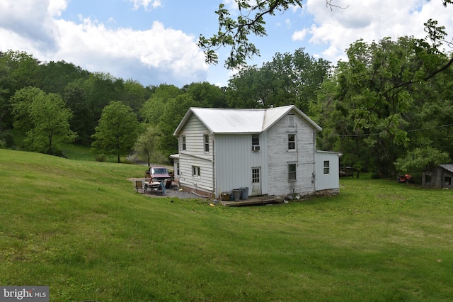 rear view of house featuring a yard