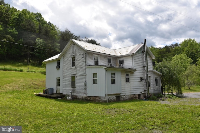 rear view of property with a yard