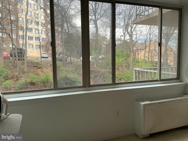 unfurnished sunroom featuring radiator and a wealth of natural light