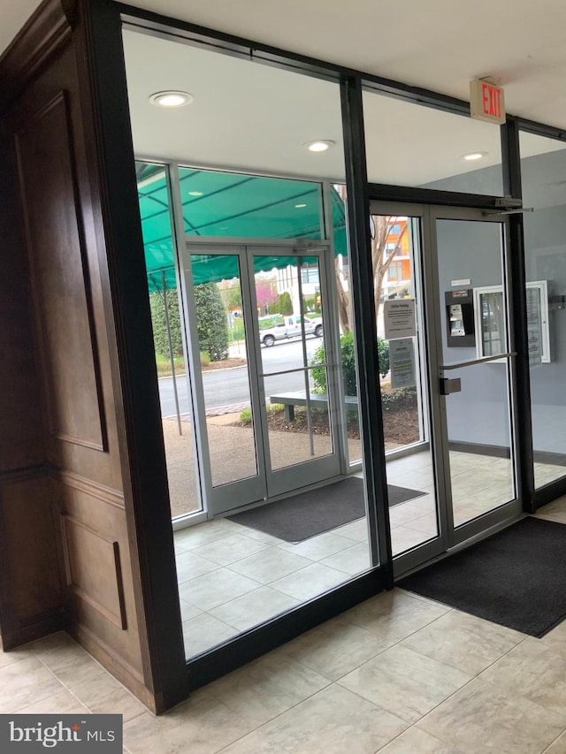 doorway with light tile patterned floors