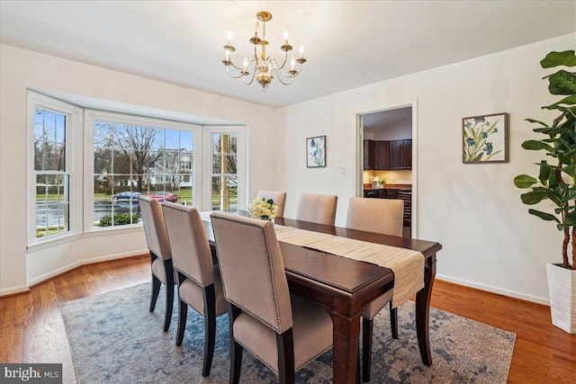 dining space with an inviting chandelier and hardwood / wood-style floors