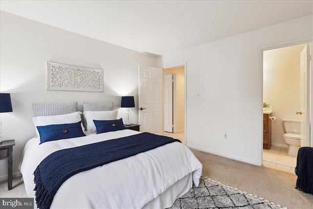 carpeted bedroom featuring ensuite bathroom